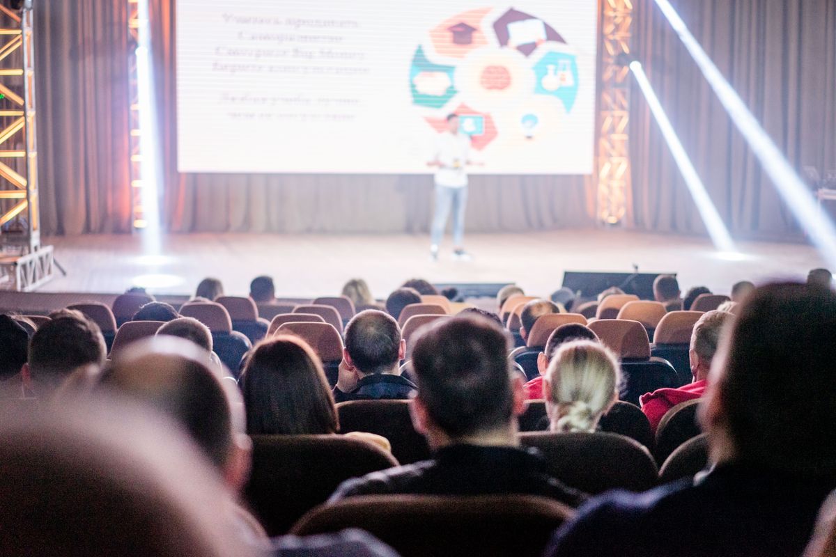 Audience of people attending a business event; Designing Event Experiences Customers